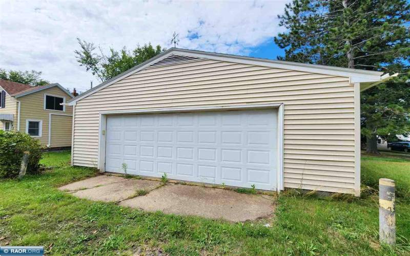 2-stall garage with newer roof, vinyl siding and aluminum soffits, fascia and gutters