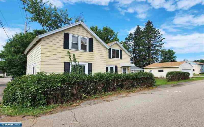 Steel siding, newer roof, front wood deck and 2-stall garage. View from 1st Ave S