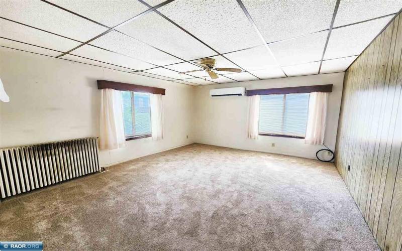 Main floor living area with heat / cool mini split and ceiling fan.