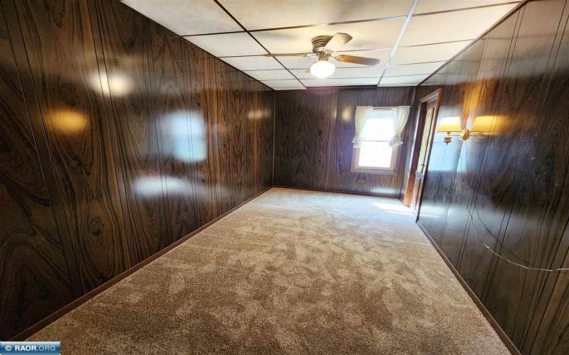 Main floor bedroom with closet and ceiling fan